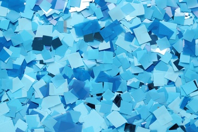 Photo of Light blue confetti as background, top view