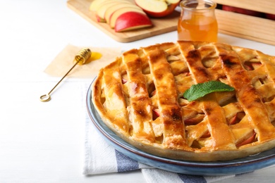 Photo of Fresh traditional apple pie on white table, closeup