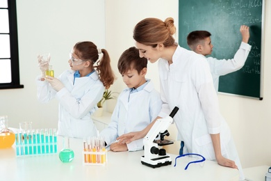 Photo of Teacher and pupils at chemistry lesson in classroom