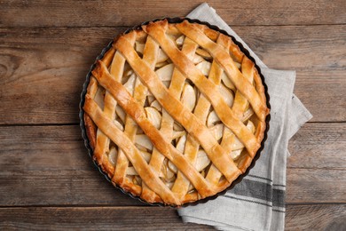 Photo of Delicious traditional apple pie on wooden table, top view