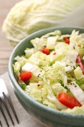 Photo of Tasty salad with Chinese cabbage in bowl on table, closeup