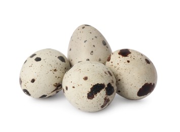 Photo of Beautiful speckled quail eggs on white background