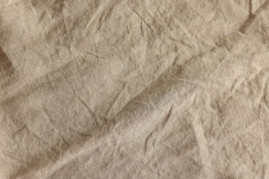 Photo of Beautiful beige fabric as background, top view