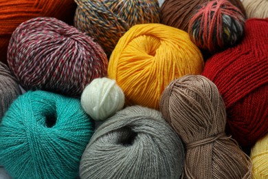 Photo of Many different soft woolen yarns as background, closeup