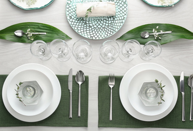 Elegant festive setting on white wooden table, flat lay