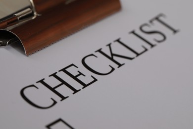 Photo of Closeup view of clipboard with inscription Checklist