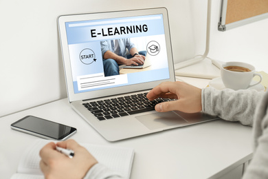 Image of Man using laptop for online studying indoors, closeup. Adult education 