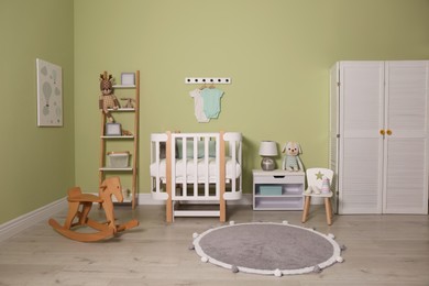 Baby room interior with stylish wooden furniture