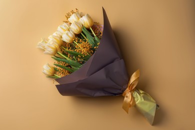 Photo of Bouquet with beautiful tulips and mimosa flowers on yellow background, top view