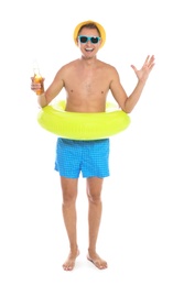 Photo of Shirtless man with inflatable ring and bottle of drink on white background