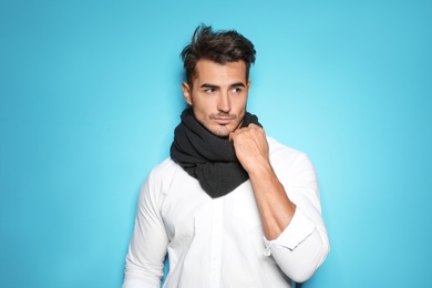 Photo of Young man with trendy hairstyle posing on color background