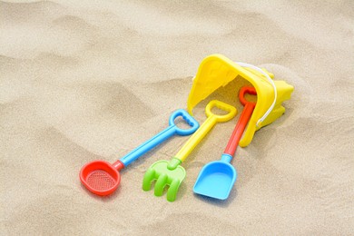 Photo of Set of colorful beach toys on sand
