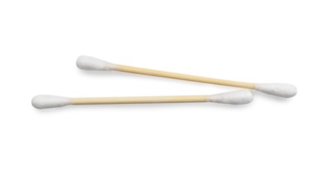 Photo of Wooden cotton buds on white background, top view