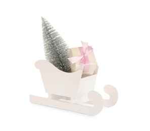 Photo of Wooden sleigh with decorative fir tree and present on white background. Christmas holidays