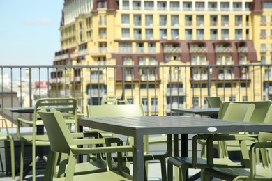 Photo of Observation area cafe. Tables and chairs on terrace against beautiful cityscape