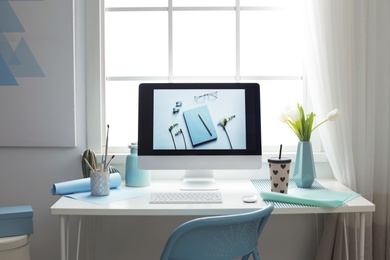 Photo of Stylish workplace interior with modern computer on desk