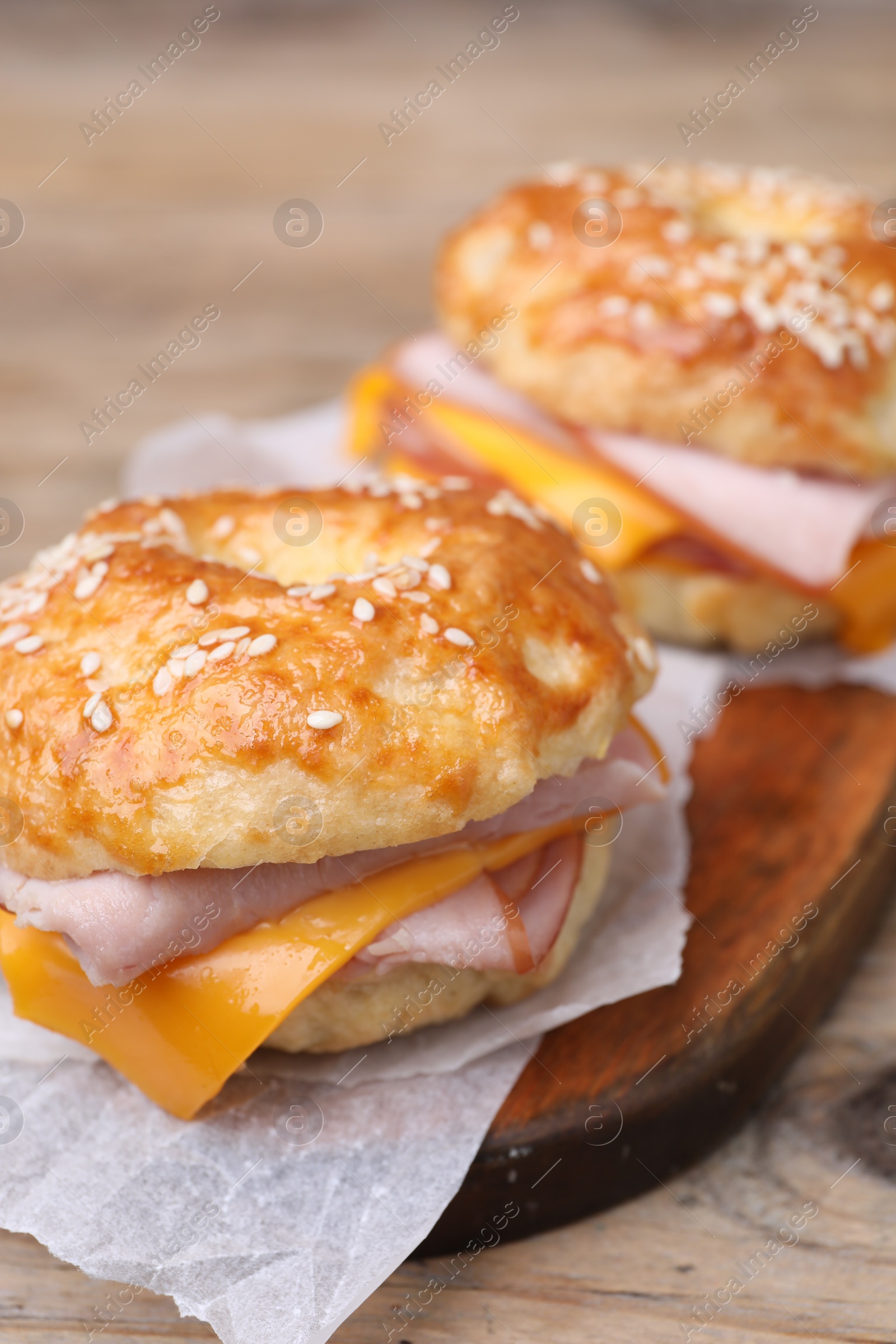 Delicious bagels with ham and cheese on table, closeup Photo of Delicious bagels with ham and cheese on table, closeup