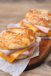 Photo of Delicious bagels with ham and cheese on table, closeup