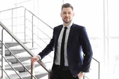 Photo of Male lawyer standing near stairs in office