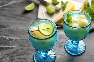 Photo of Melon ball cocktail served on black marble table