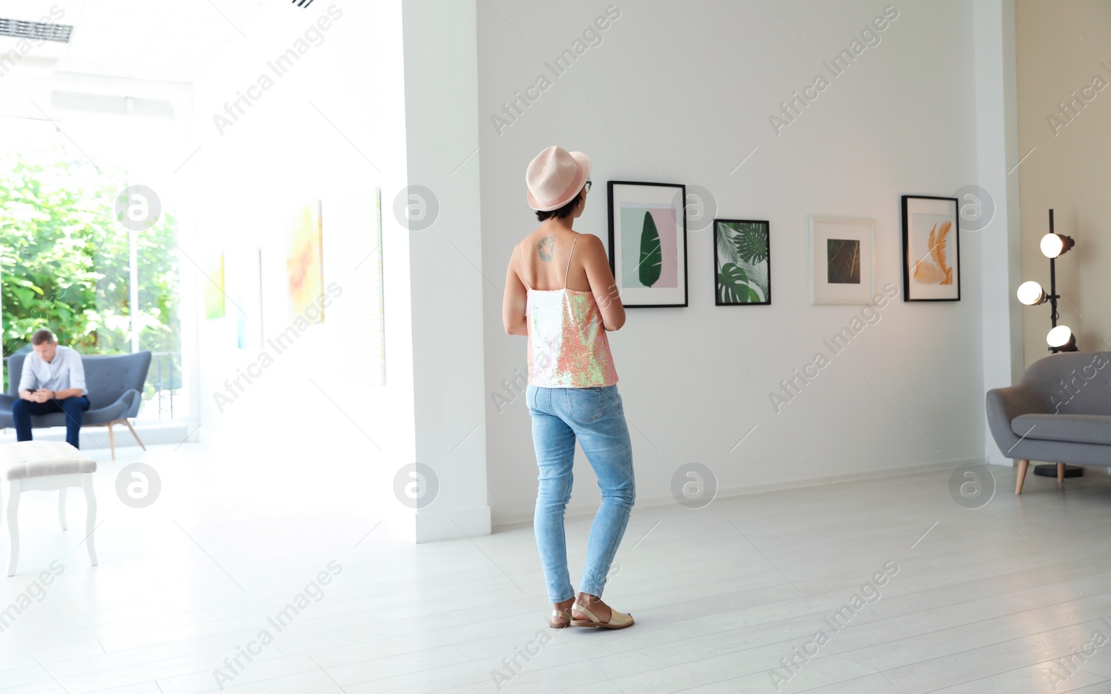 Photo of Young woman at exhibition in art gallery