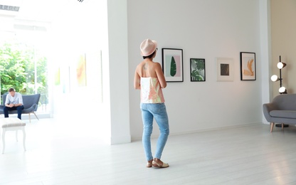 Photo of Young woman at exhibition in art gallery