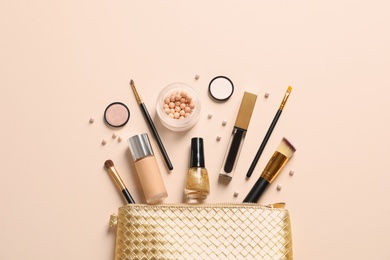 Photo of Cosmetic bag and different luxury makeup products on color background, flat lay
