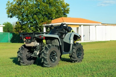 Photo of Modern quad bike near house on sunny day, space for text
