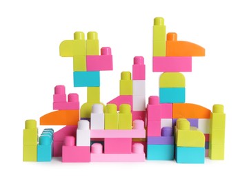 Photo of Toy castle made of bright building blocks on white background