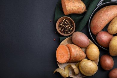 Photo of Different types of fresh potatoes on black table, flat lay. Space for text