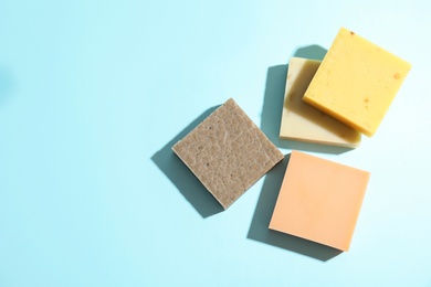 Photo of Hand made soap bars on color background, top view. Space for text