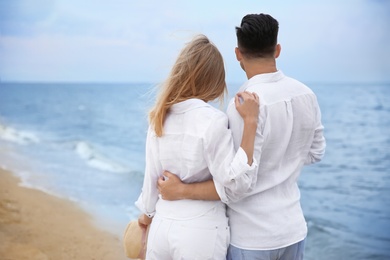 Photo of Happy couple having romantic walk on beach