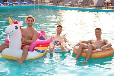 Photo of Happy young friends relaxing in swimming pool