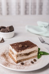 Photo of Tiramisu cake with coffee beans on table