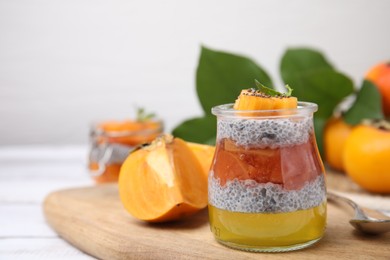 Photo of Delicious dessert with persimmon and chia seeds on table. Space for text