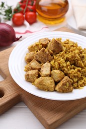 Photo of Platedelicious rice with chicken on white wooden table, closeup