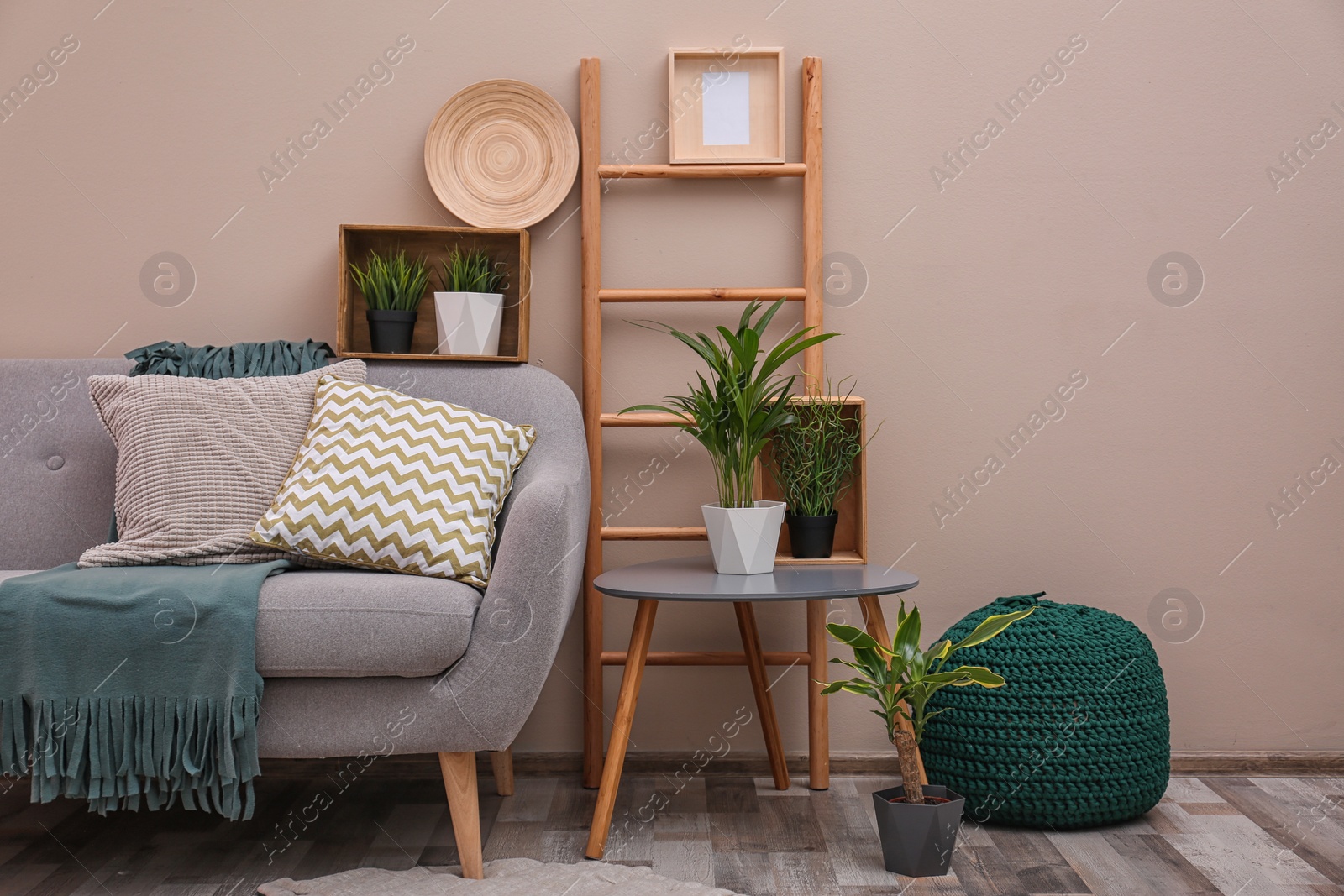 Photo of Modern eco style interior of living room with wooden crates and sofa near color wall