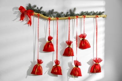 New Year advent calendar hanging on white wall indoors