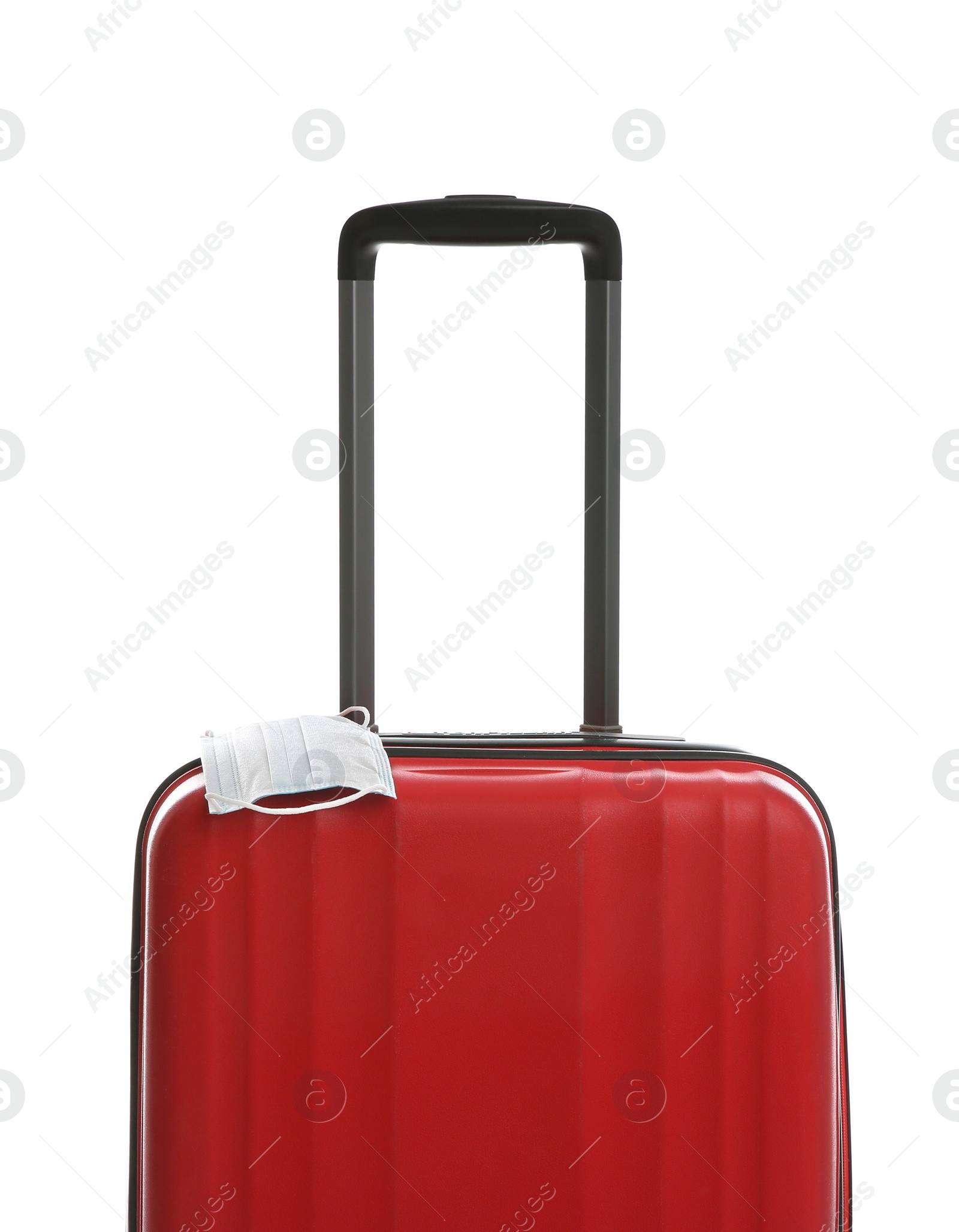 Photo of Stylish red suitcase and protective mask on white background. Travelling during coronavirus pandemic