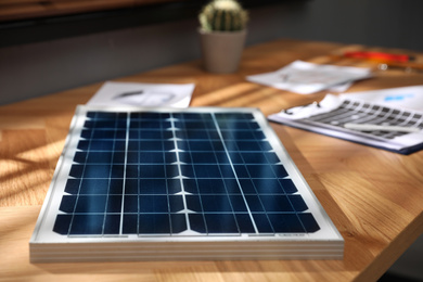 Photo of Solar panel on wooden table in office