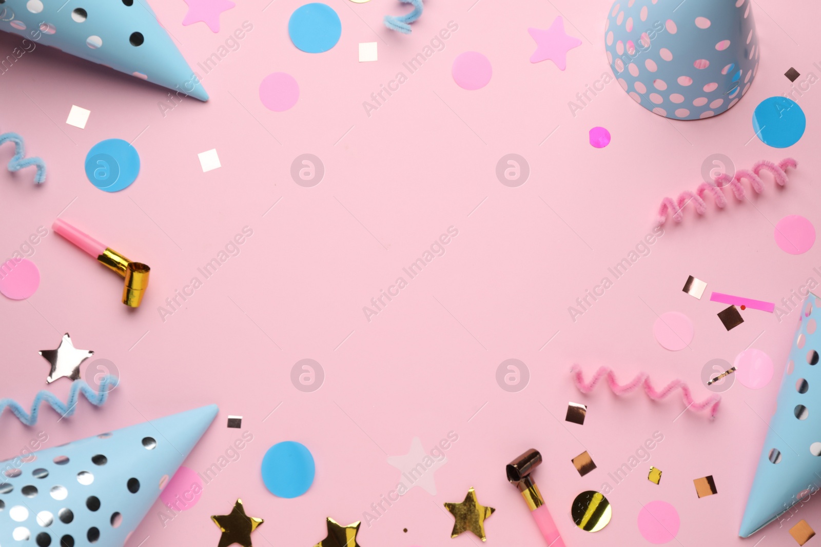 Photo of Frame of party items on pink background, flat lay. Space for text