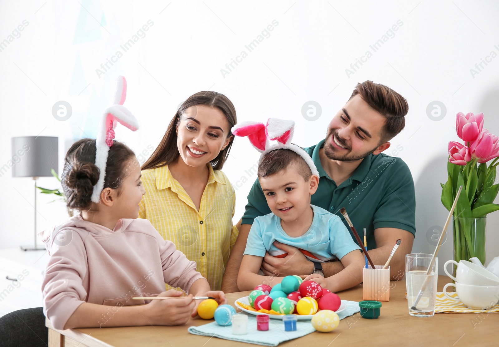 Photo of Happy family with Easter eggs at home. Festive tradition