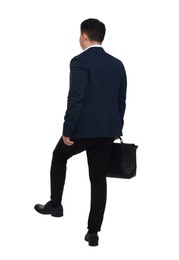 Photo of Businessman in suit with briefcase walking on white background, back view