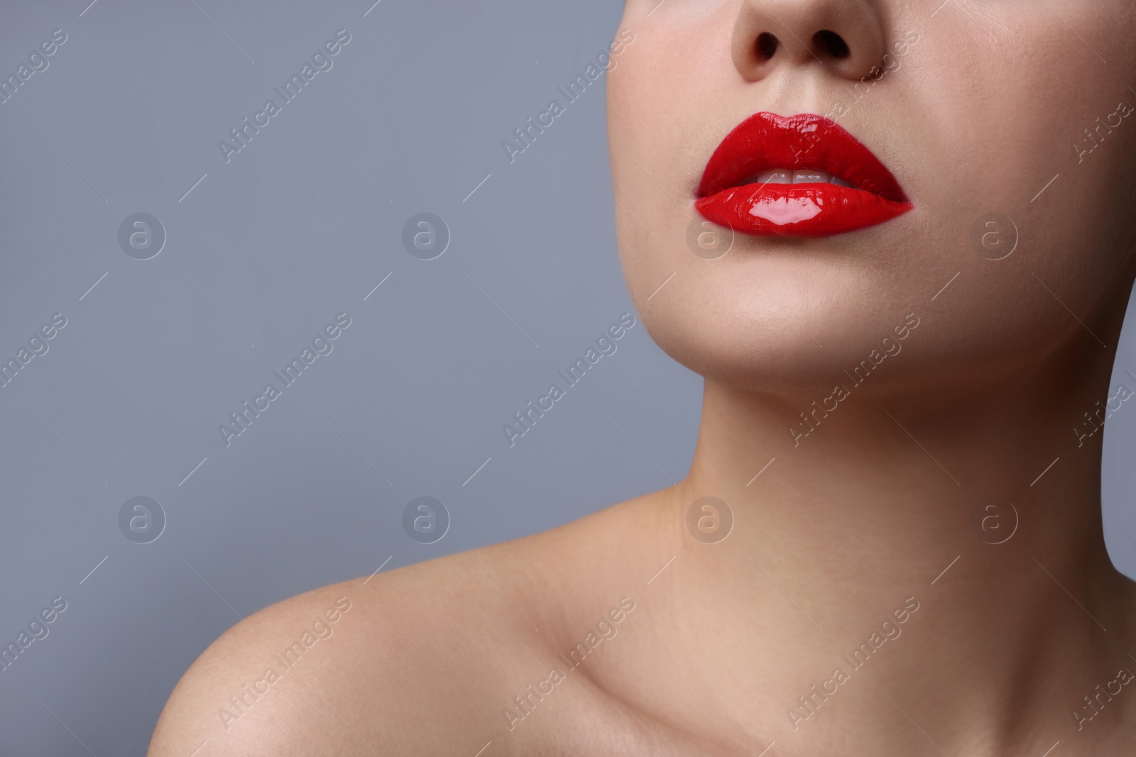 Photo of Closeup view of woman with beautiful full lips on grey background. Space for text