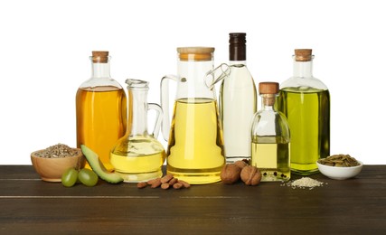 Vegetable fats. Different cooking oils and ingredients on wooden table against white background