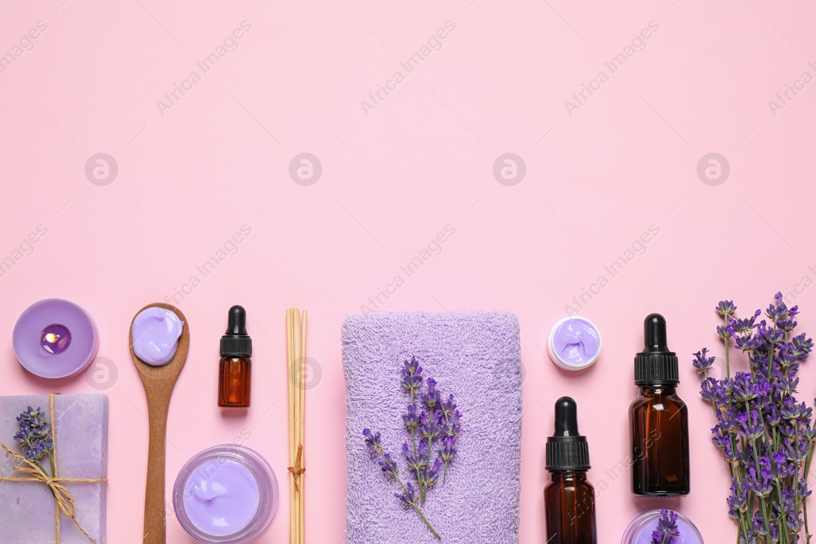 Photo of Cosmetic products and lavender flowers on pink background, flat lay. Space for text