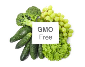 Photo of Tasty fresh GMO free products and paper card on white background, top view