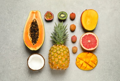 Photo of Fresh ripe papaya and other fruits on light grey table, flat lay