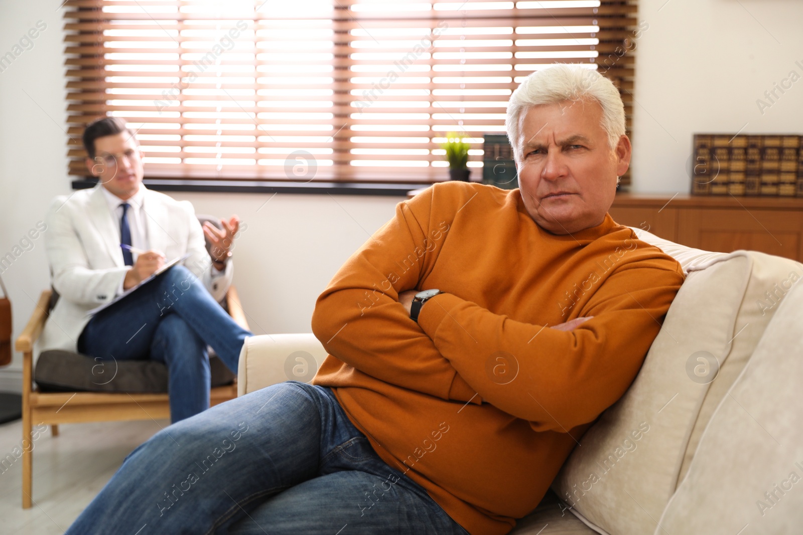 Photo of Professional psychotherapist working with patient in office