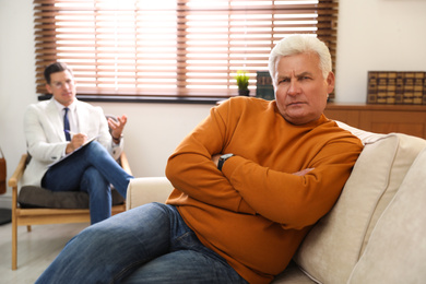 Professional psychotherapist working with patient in office